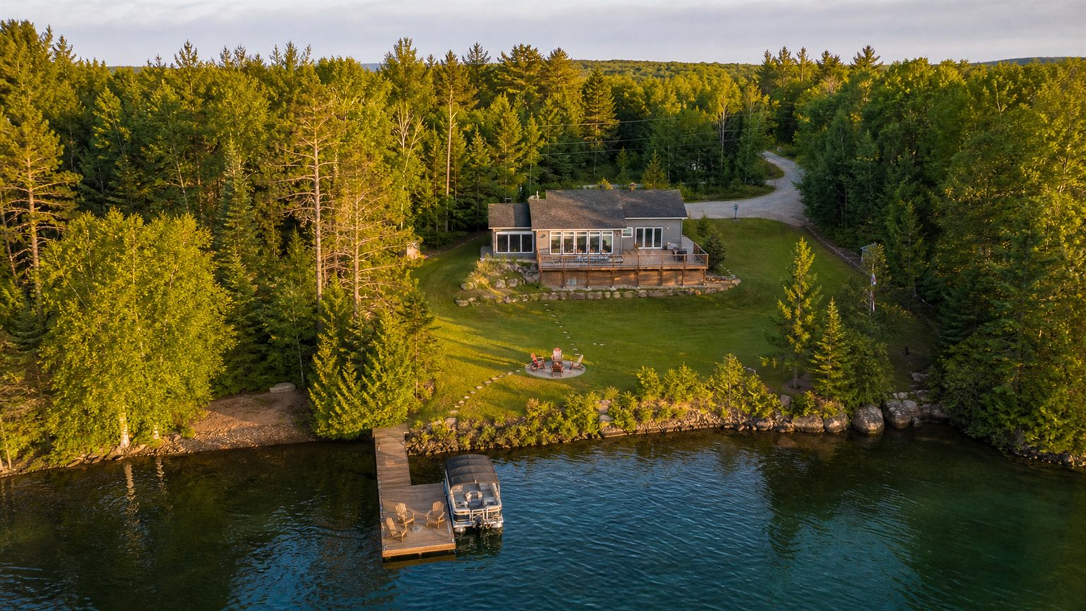 Aerial view of a cottage property near water